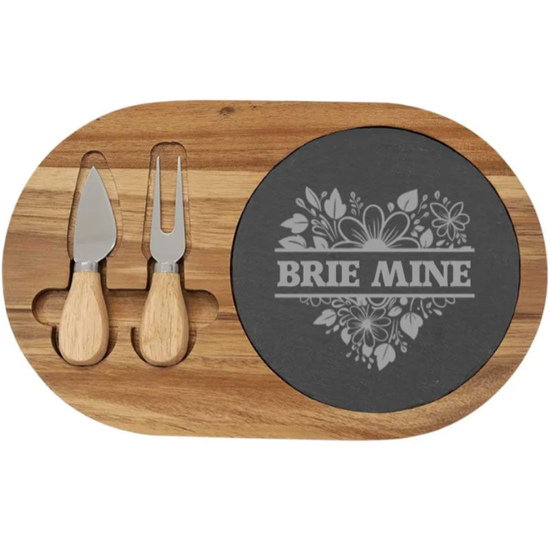 Acacia wood cheese board set with knife and fork, embellished with engraved slate family names and monograms., Cheese tool set