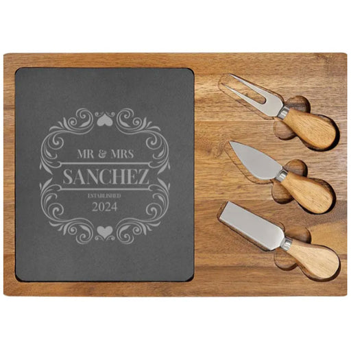 Acacia wood cheese board set with knife, spreader, and fork, adorned with engraved slate family names and monograms.3-piece cheese tool set