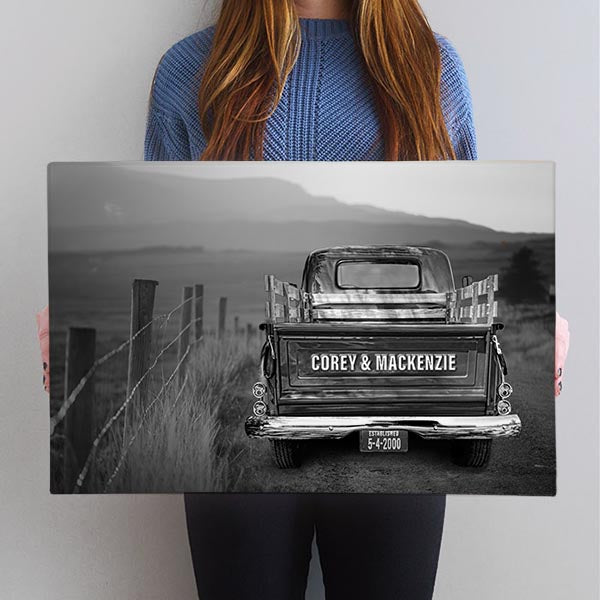 Customized Vintage Truck Canvas Print in Black and White, showcasing a classic truck on an old country road at sunset. Tailgate personalization available, with options to choose from 15 truck colors. Perfect for stylish home decor and a unique, monochromatic gift for couples.