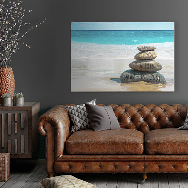 Close-up of the Stacked Stones Sky Canvas, showcasing the bright blue sky and digitally carved stones with personalized text, a unique addition to beach wall art.