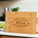 Rectangular bamboo cutting board featuring family name butcher block inlay, elegant kitchen decor addition.