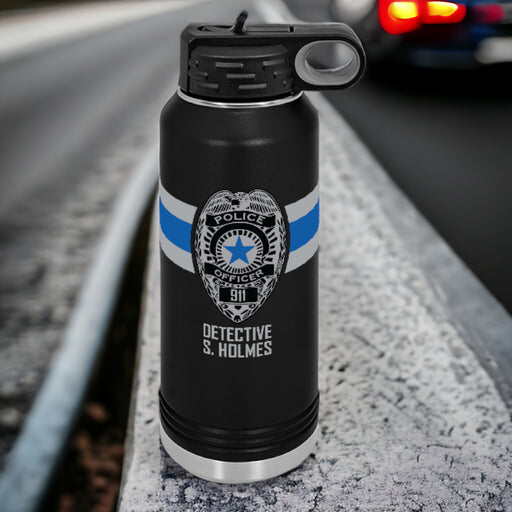 Close-up of custom police badge stainless steel tumbler, highlighting personalized name and badge number, the perfect gift for law enforcement professionals.