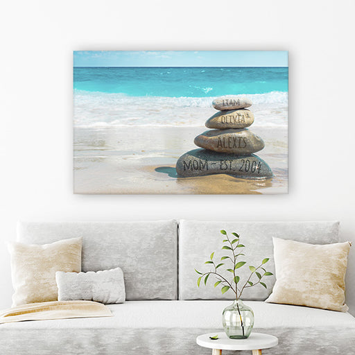Close-up of the Stacked Stones at the Ocean Beach Wall Art Canvas, showcasing the bright blue sky and digitally carved stones with personalized text, a unique addition to beach wall art."
